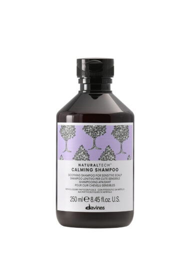 Transparente Flasche mit beruhigendem Shampoo der Marke Davines, Produktname „Calming Shampoo“